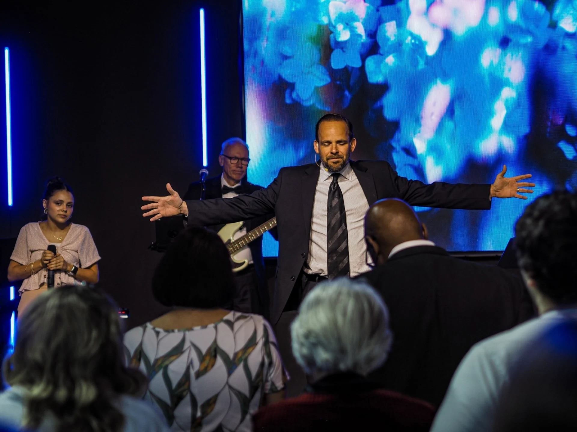 Pastor leading worship at Impact Church